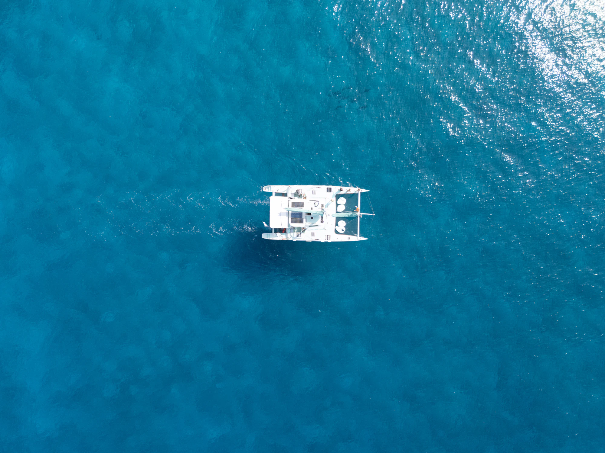 Yacht moving through tropical blue water