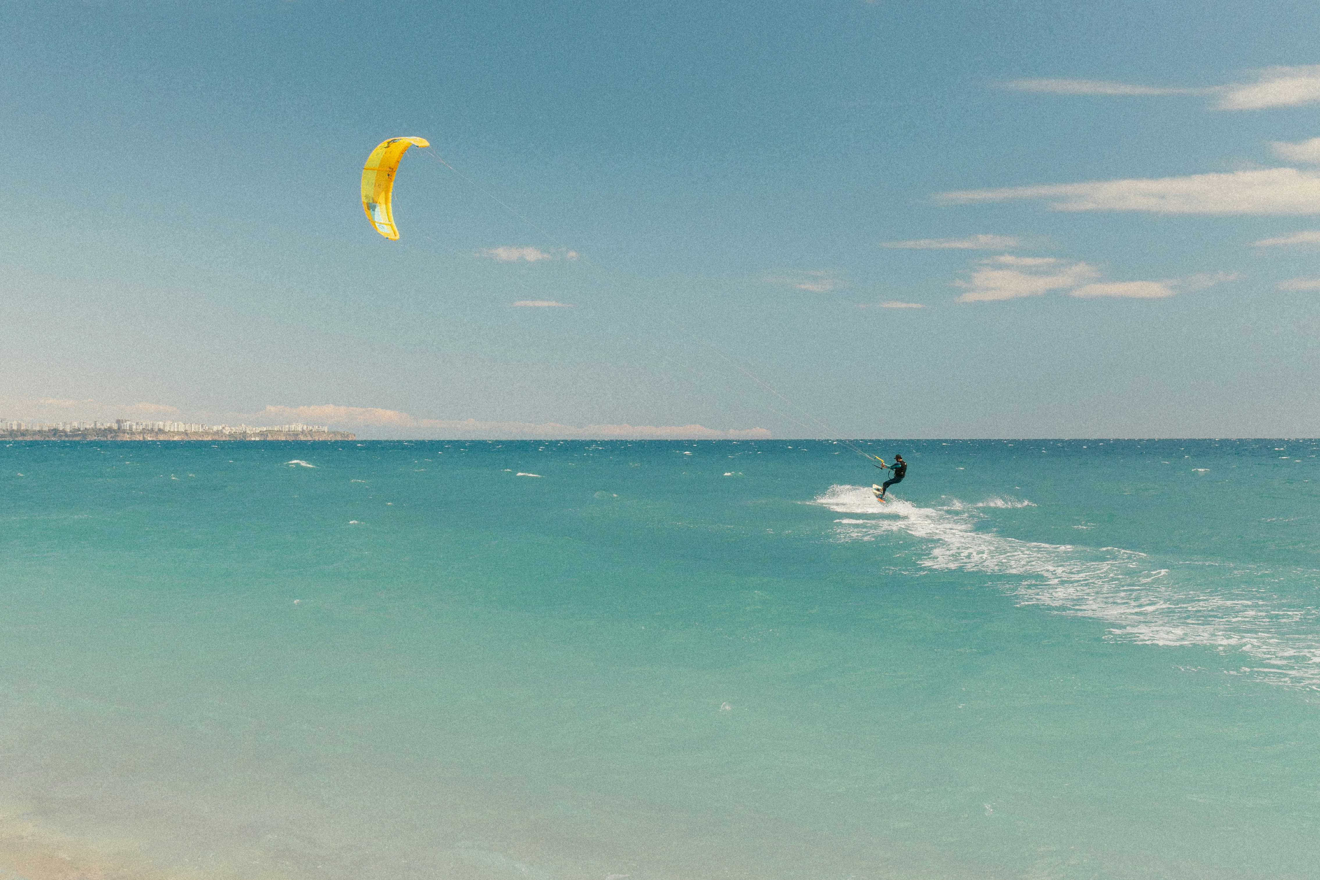Kitesurfer enjoys the ocean on a sunny day.