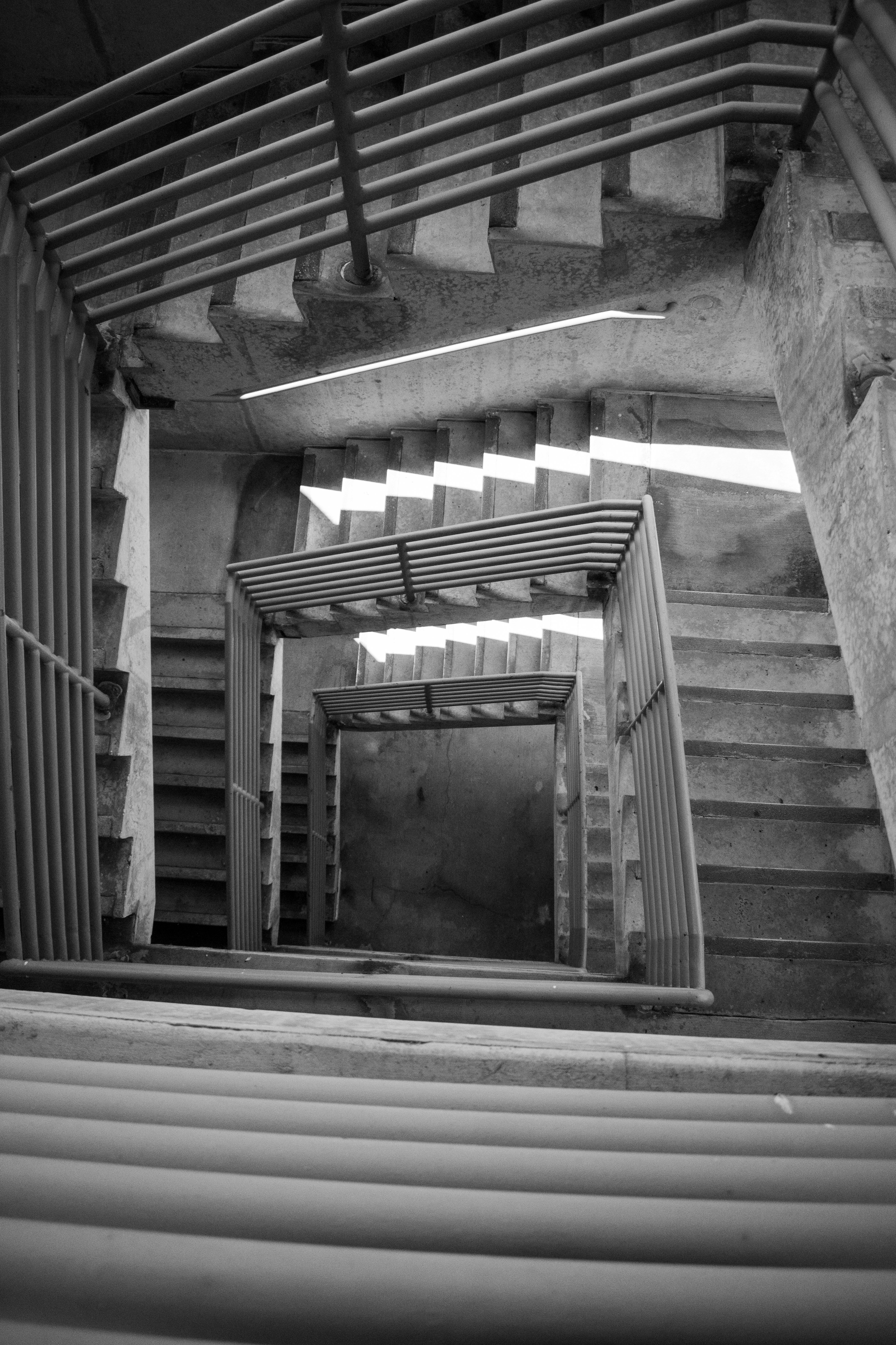 Looking down a complex, winding staircase.
