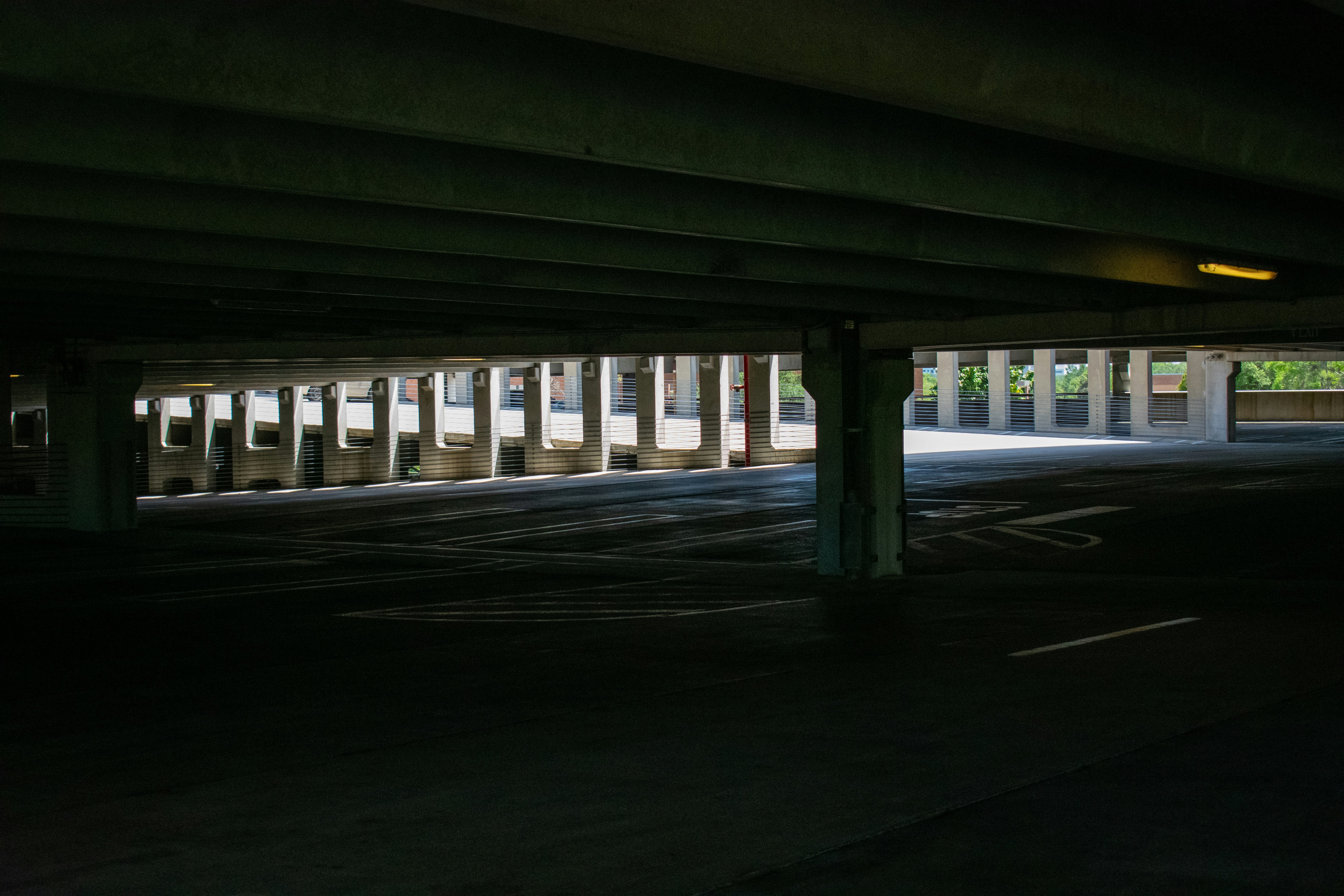 Dark, empty parking garage from a low angle.