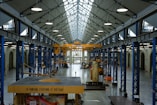 An industrial hall with machinery and high ceilings.