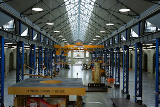 An industrial hall with machinery and high ceilings.