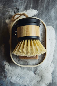 Dish brush with soap and suds.