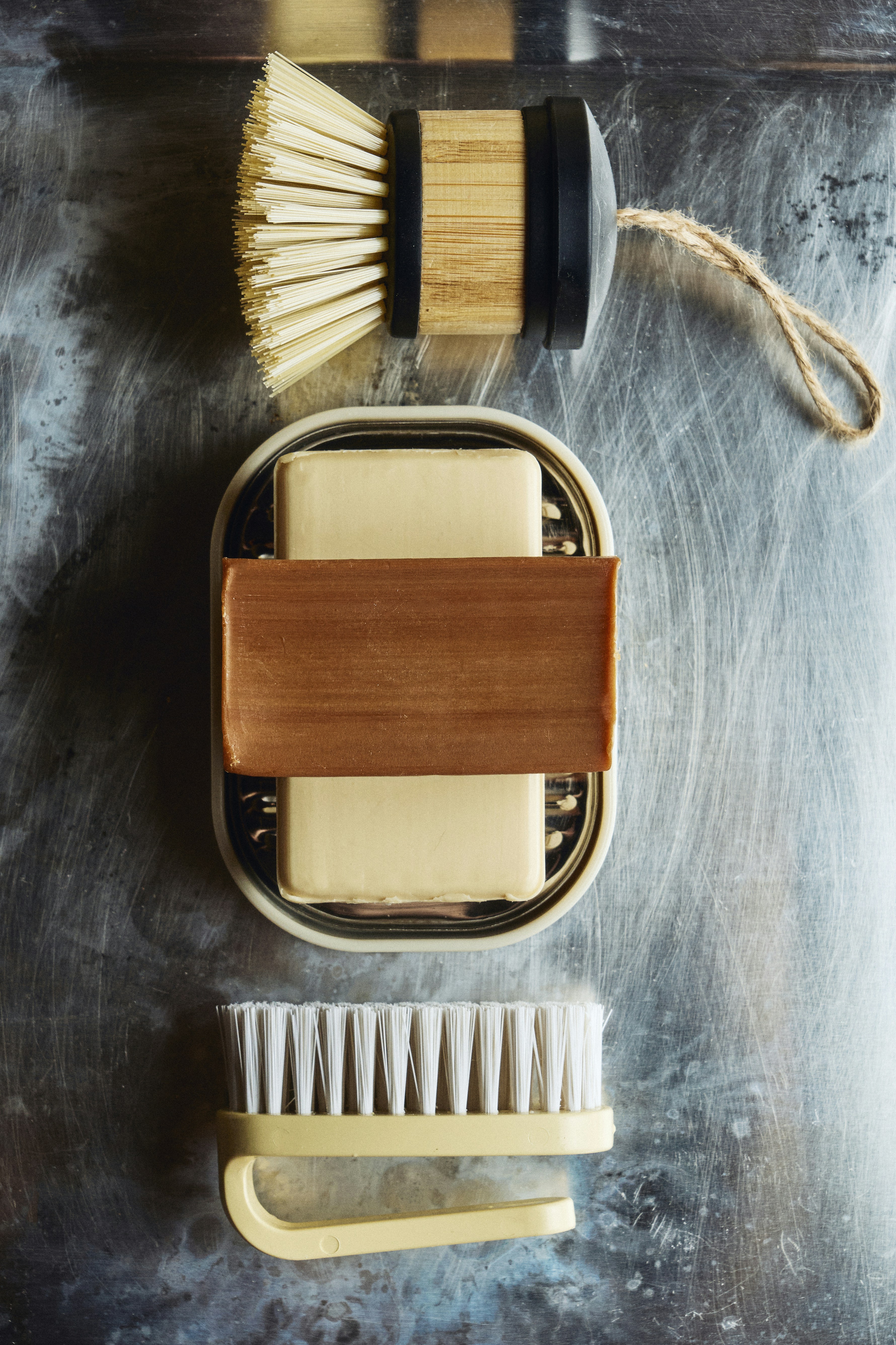 石鹸、食器用ブラシ、ネイルブラシが一緒に座っています。