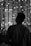 Man gazes at the city lights at night.