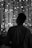 Man gazes at the city lights at night.