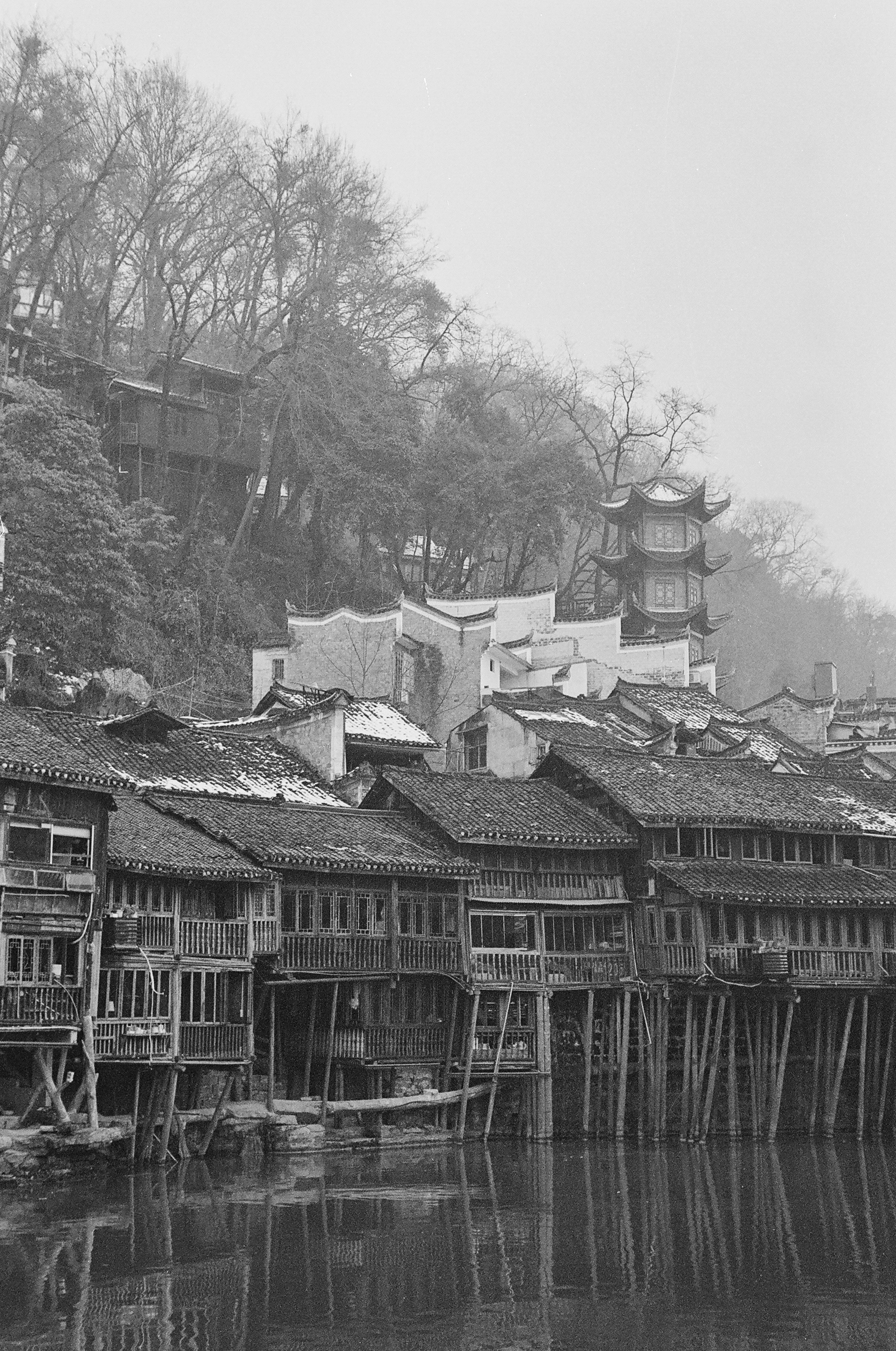 Old wooden houses line the water's edge.