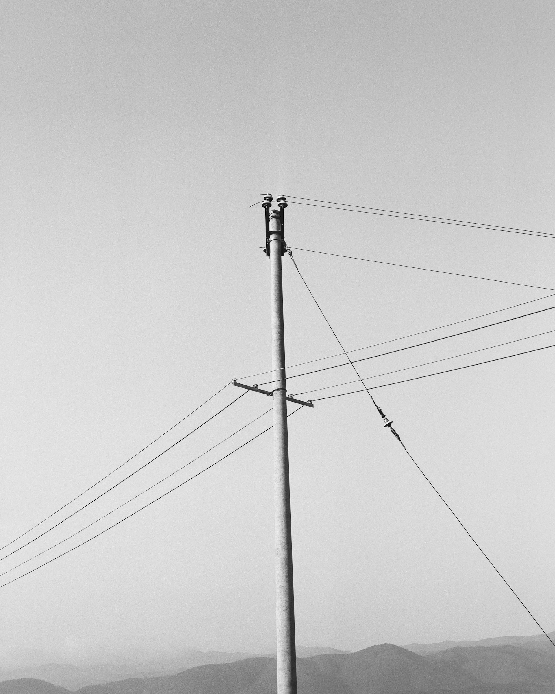 Power lines and pole against a clear sky.