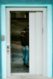 A person waits in an elevator.