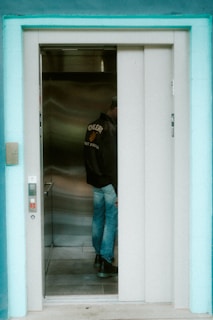 A person waits in an elevator.