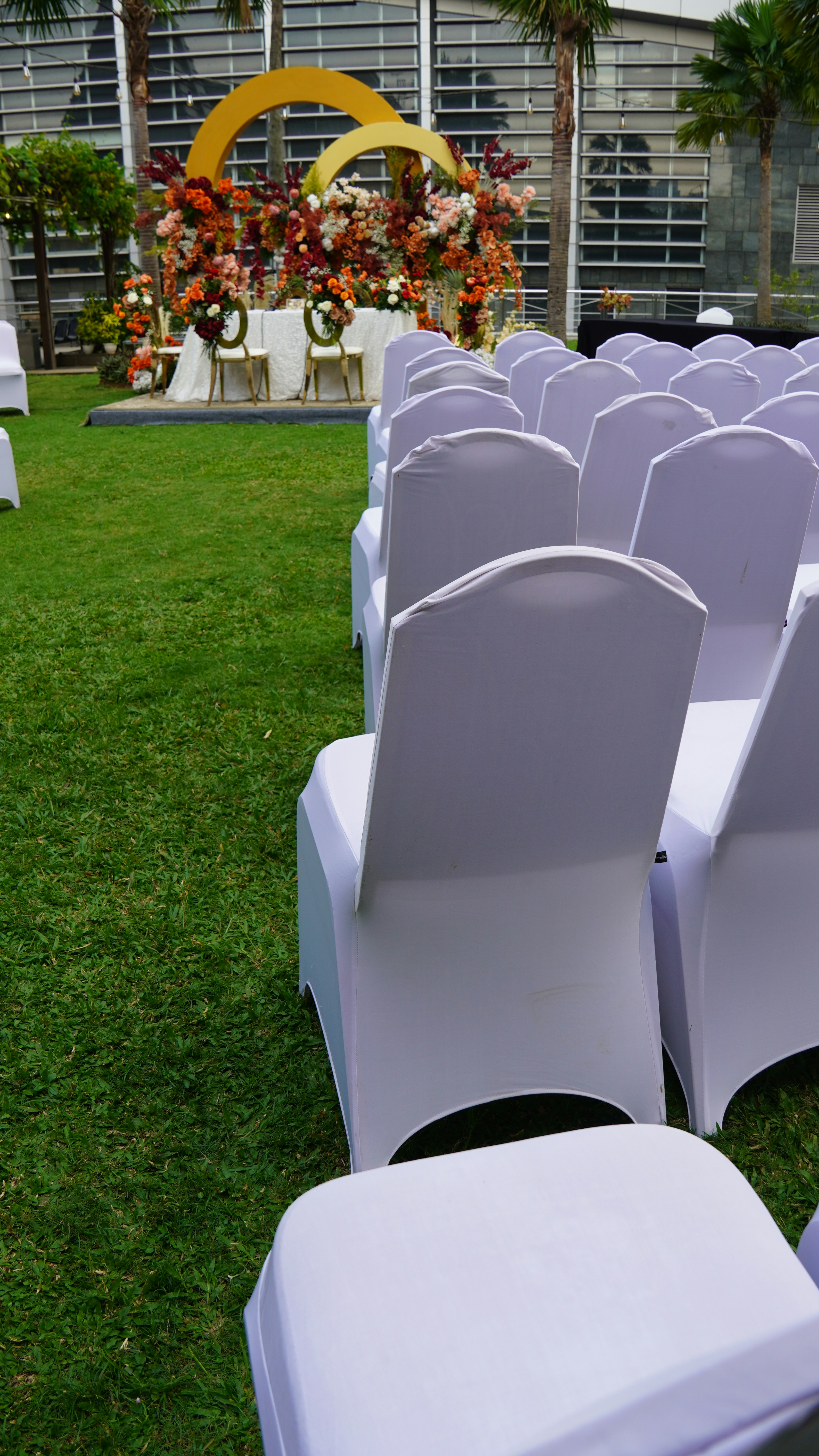 Wedding ceremony setup outdoors with rows of chairs.