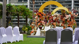 Wedding ceremony setup with flowers and decorated arches.