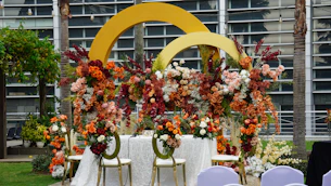 Floral arrangement decorates an outdoor event setup.