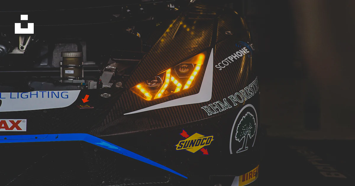 A race car with bright headlights is shown. photo – Free Lamborghini ...