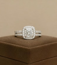 A diamond ring set sits on a display box.