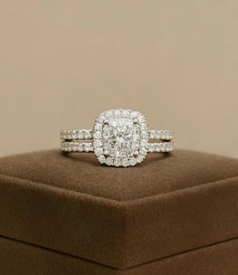 A diamond ring set sits on a display box.