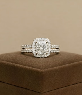 A diamond ring set sits on a display box.
