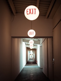 Hallway with exit signs guiding the way.