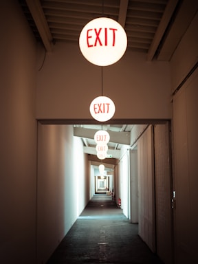 Hallway with exit signs guiding the way.