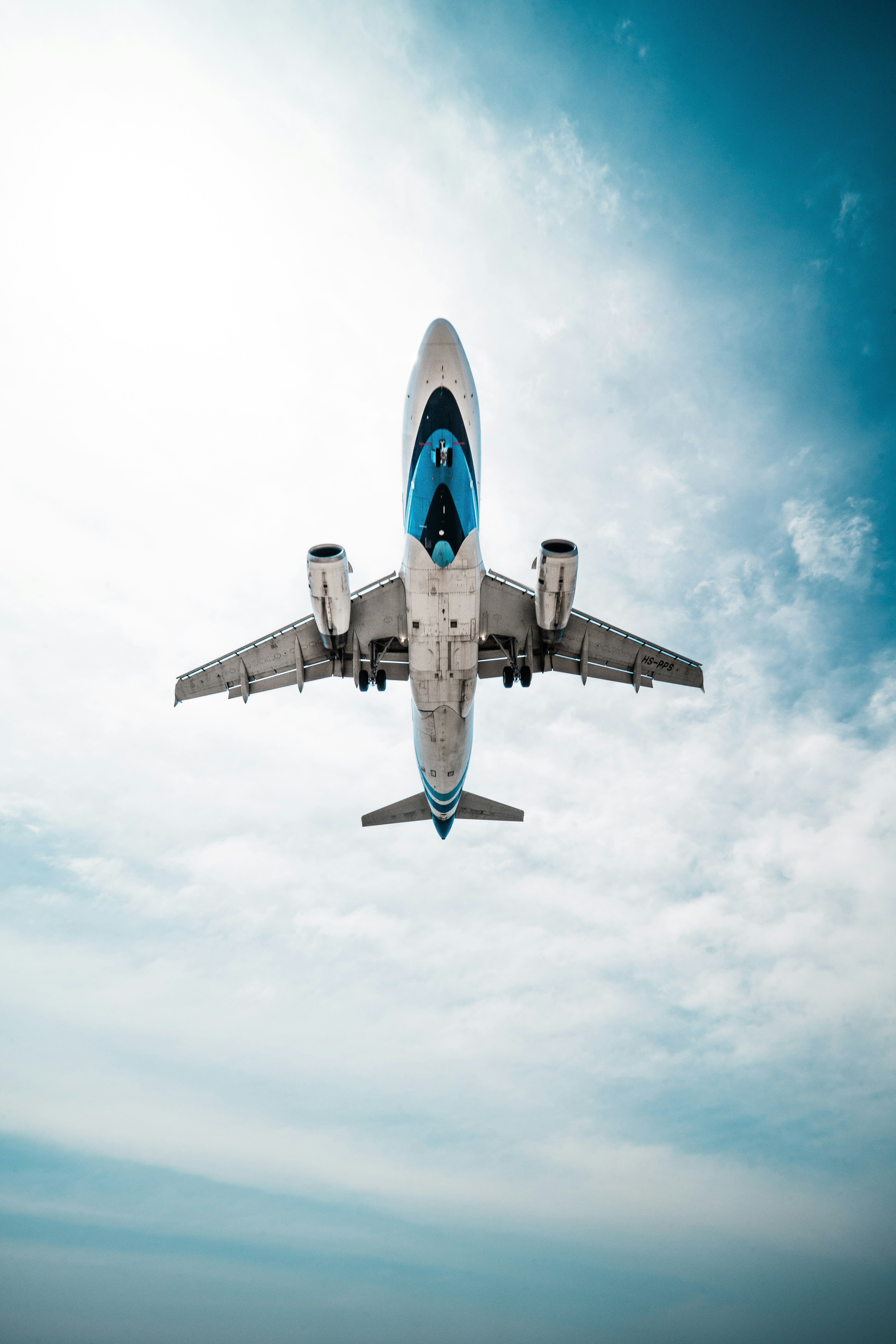 An airplane flies high above.