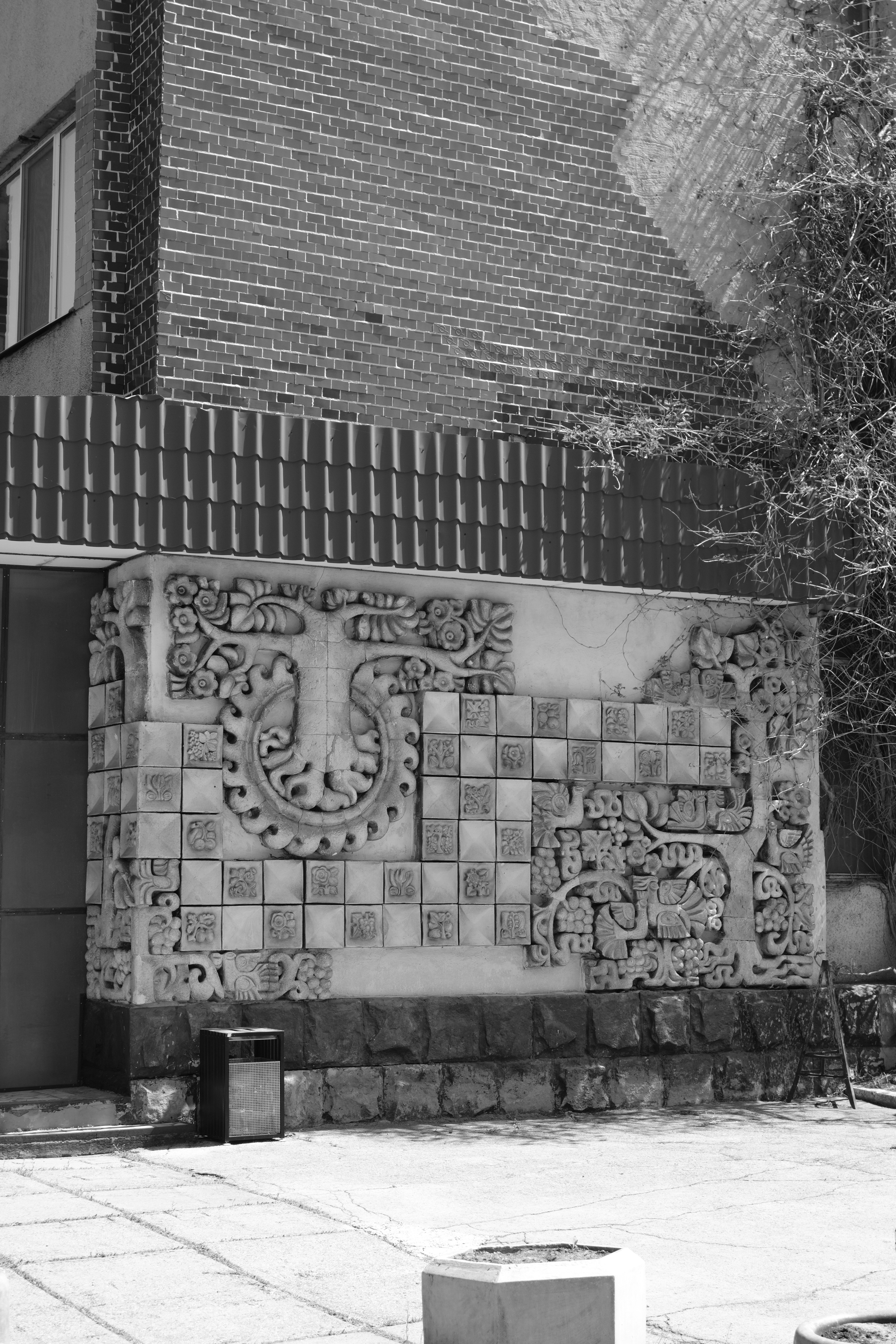 Decorated wall with architectural carvings is visible.