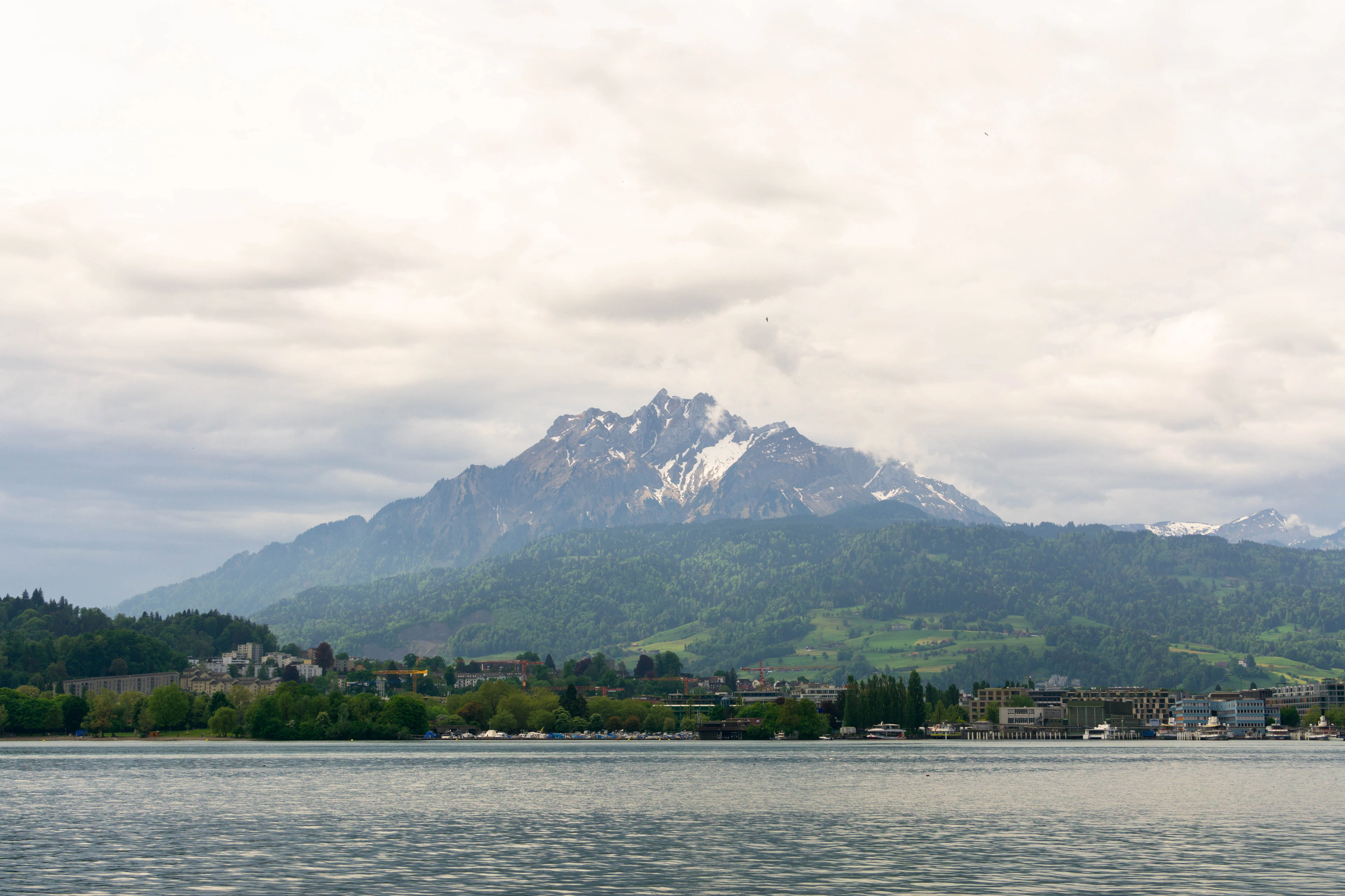 Mount Pilatus's jagged peaks rise beyond Lake Lucerne and its lakeside town.