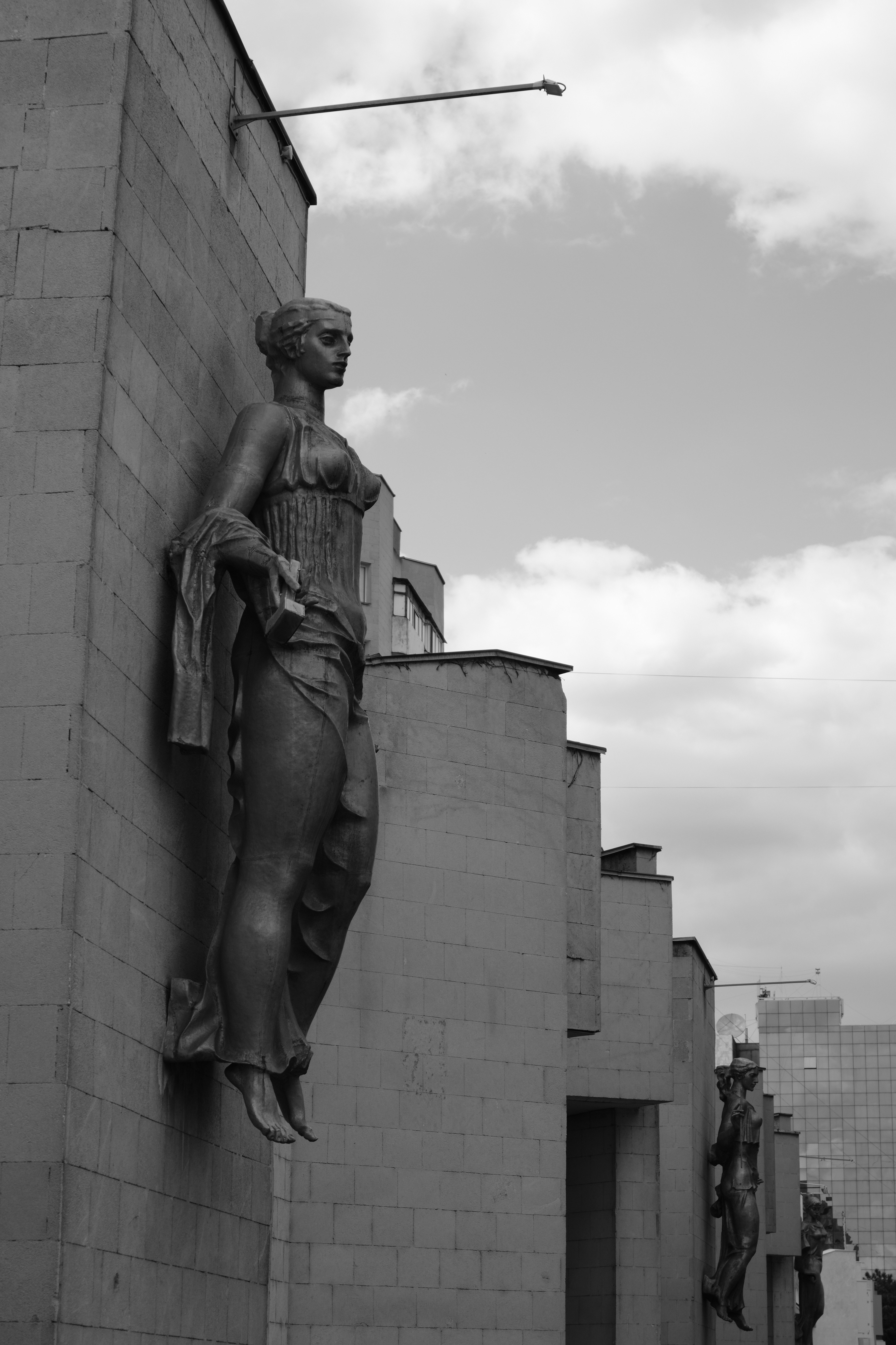 Statues adorn the wall of a building.