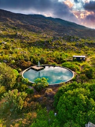 A serene pool reflects a mountain landscape.