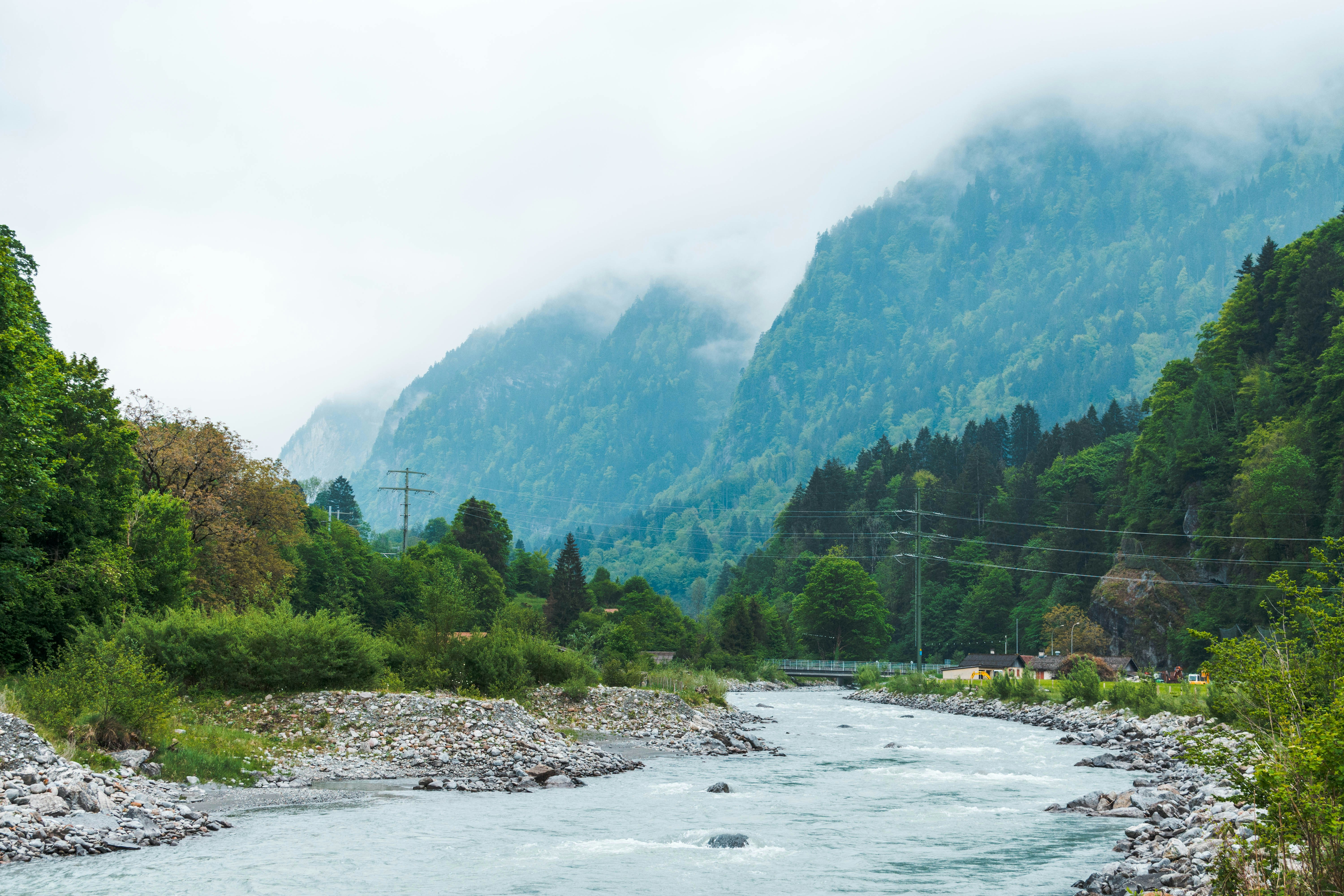 A river flows through misty mountains.