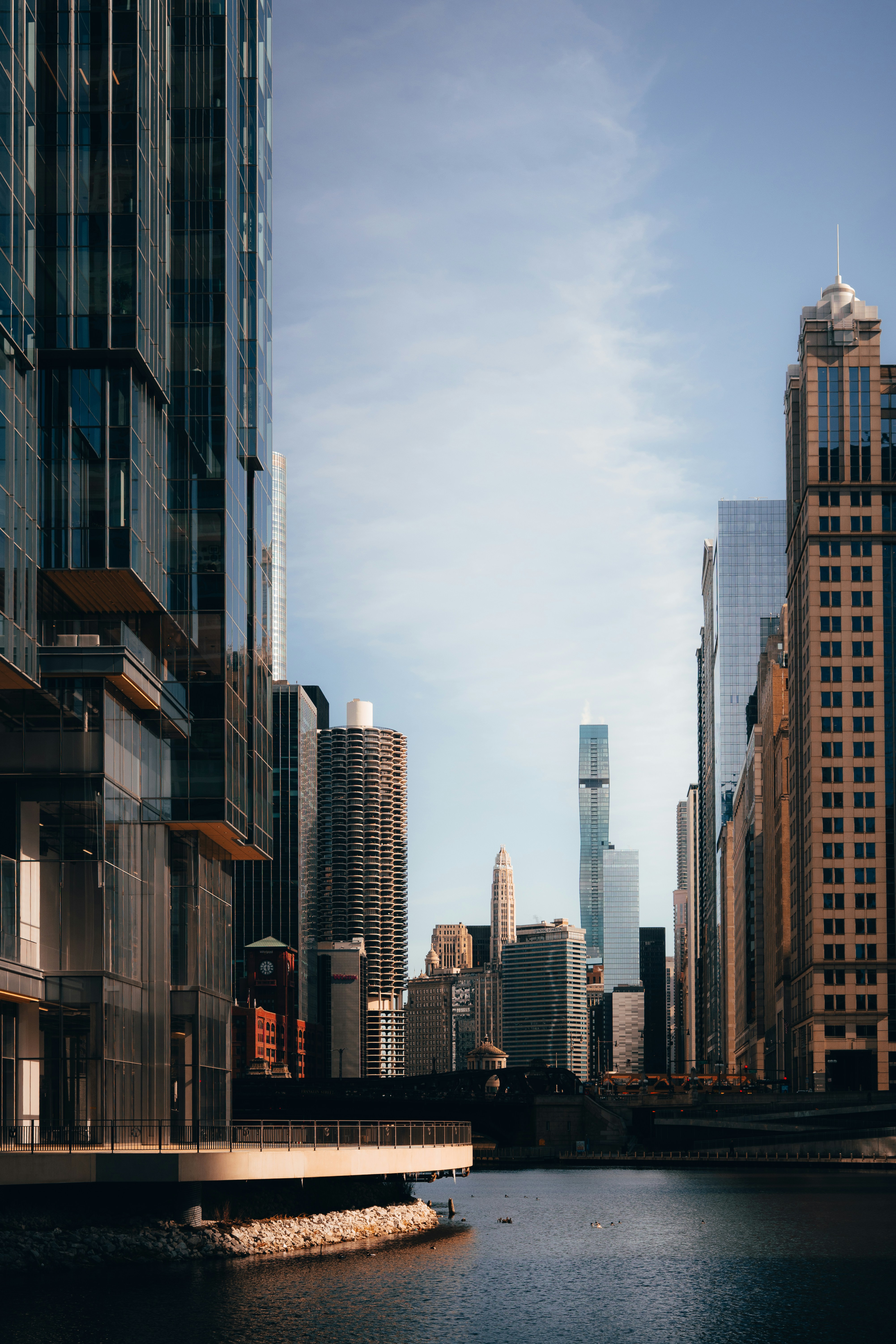 Skyscrapers line a river on a sunny day. photo – Free City skyline Image on  Unsplash, image size:3000x4500