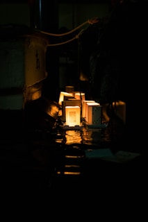 Glowing metal blocks are illuminated in a dark factory.