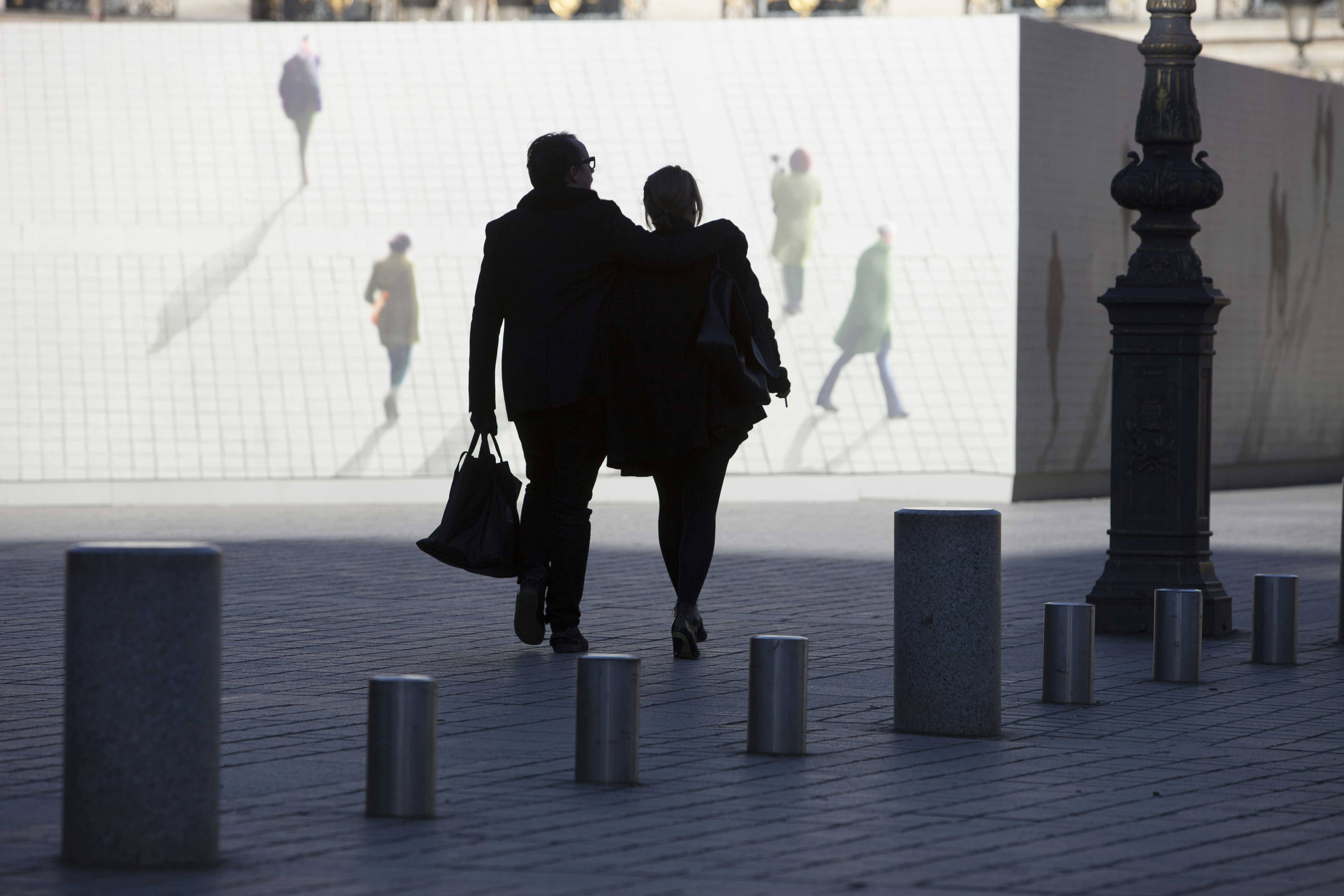 Una pareja camina con otras en el fondo.