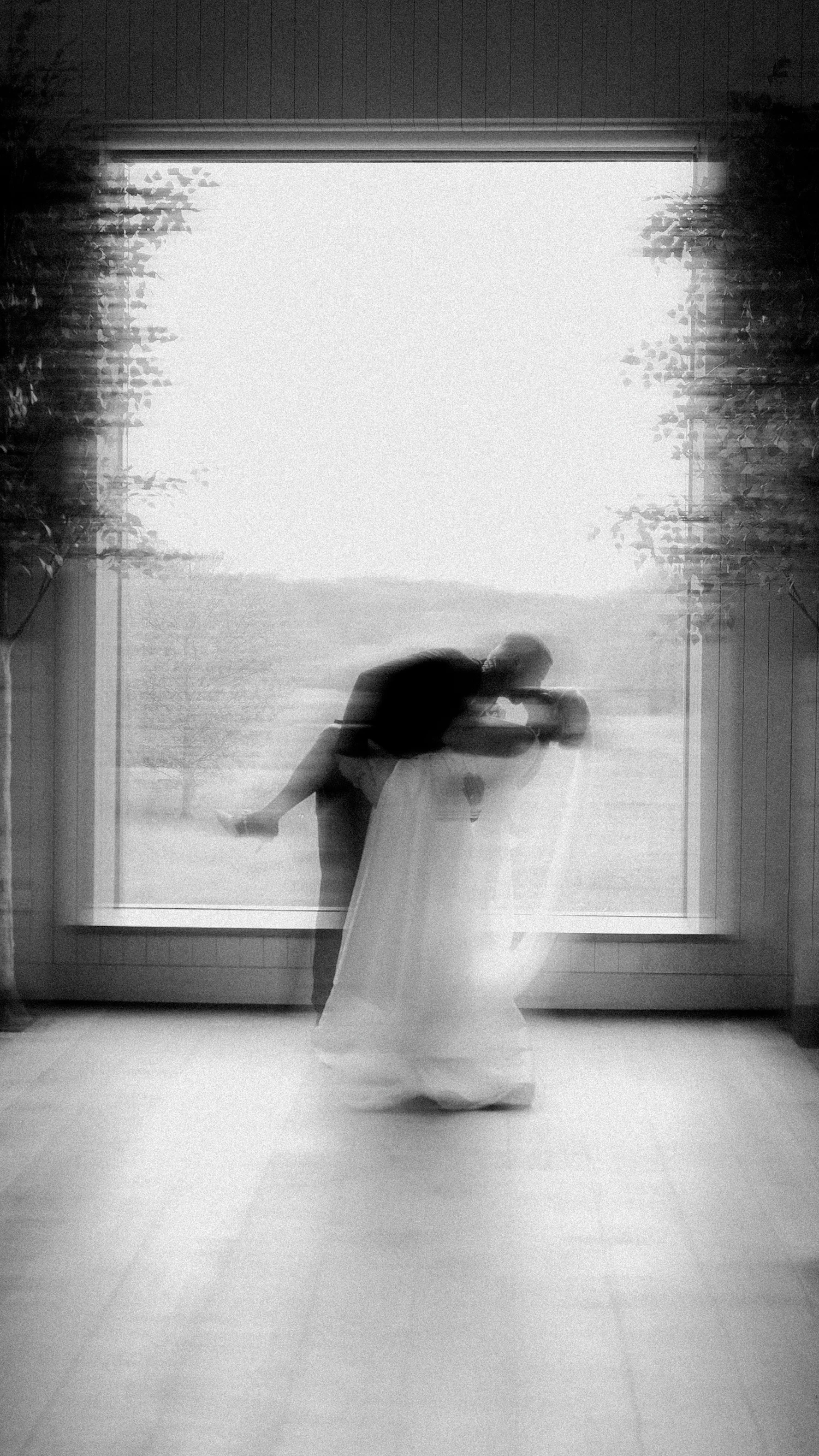 A bride crossing a doorway, blurred by a long exposure
