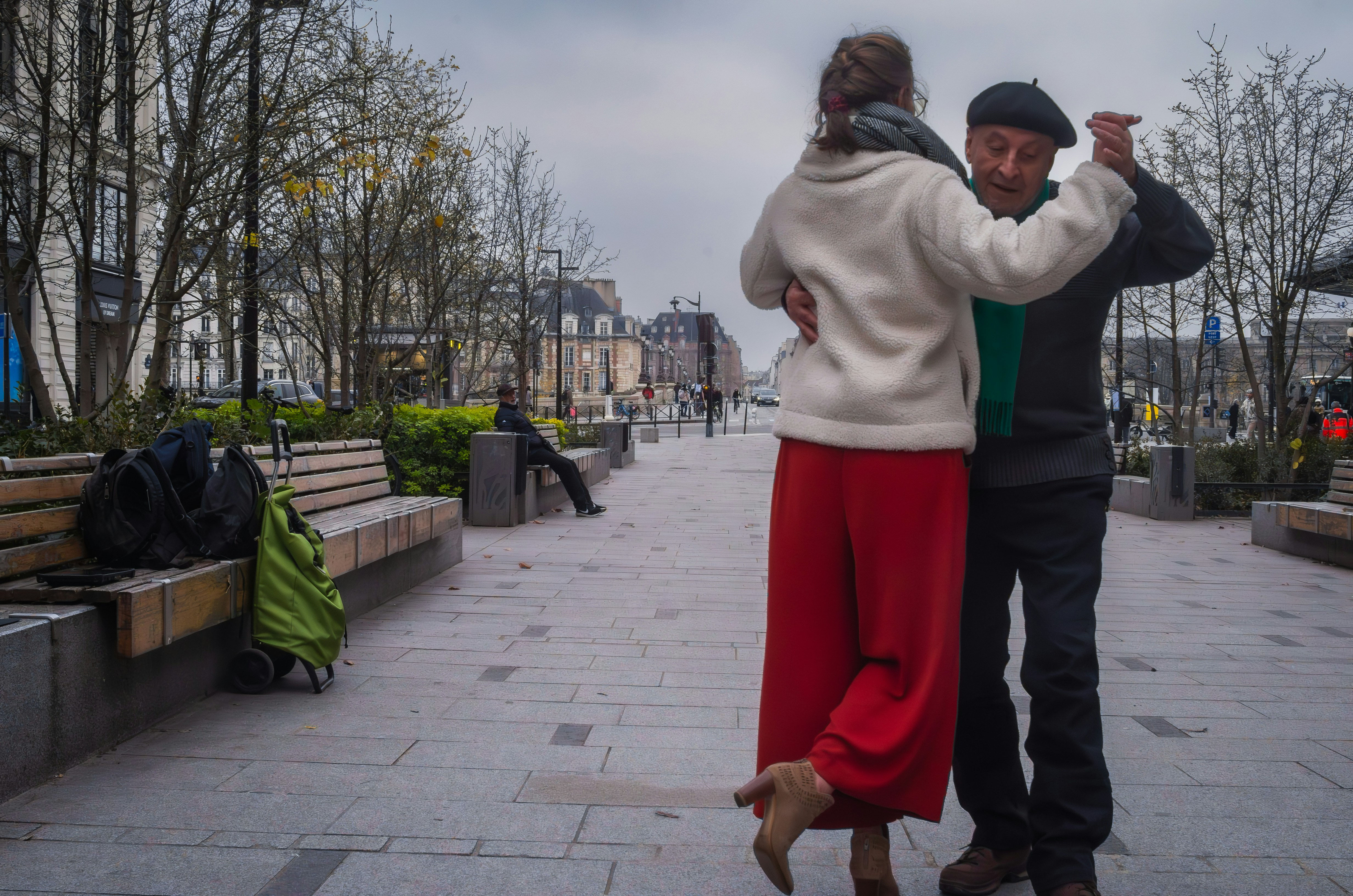 A couple gracefully dances tango in public.