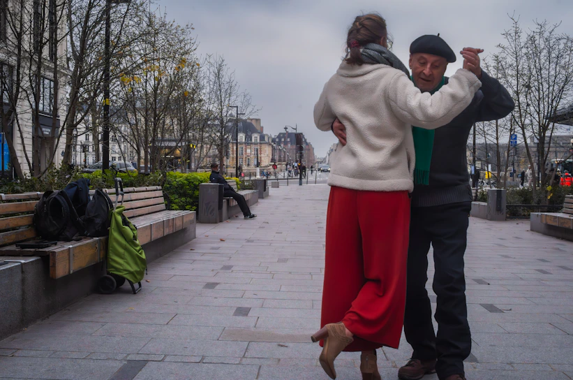 A couple gracefully dances tango in public.