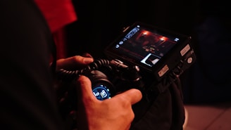 A photographer holds up a camera to film.