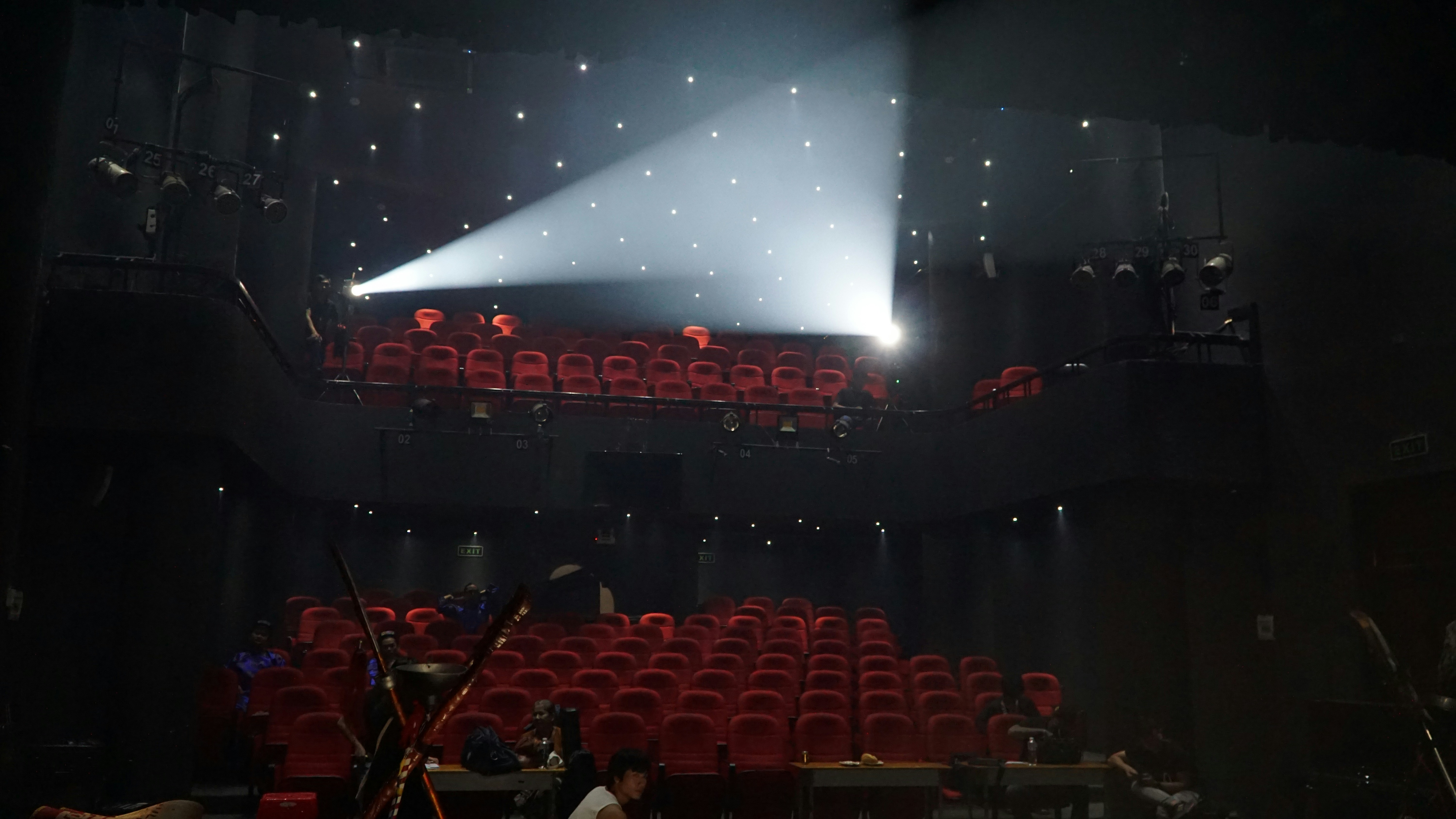 A spotlight shines on rows of red seats.