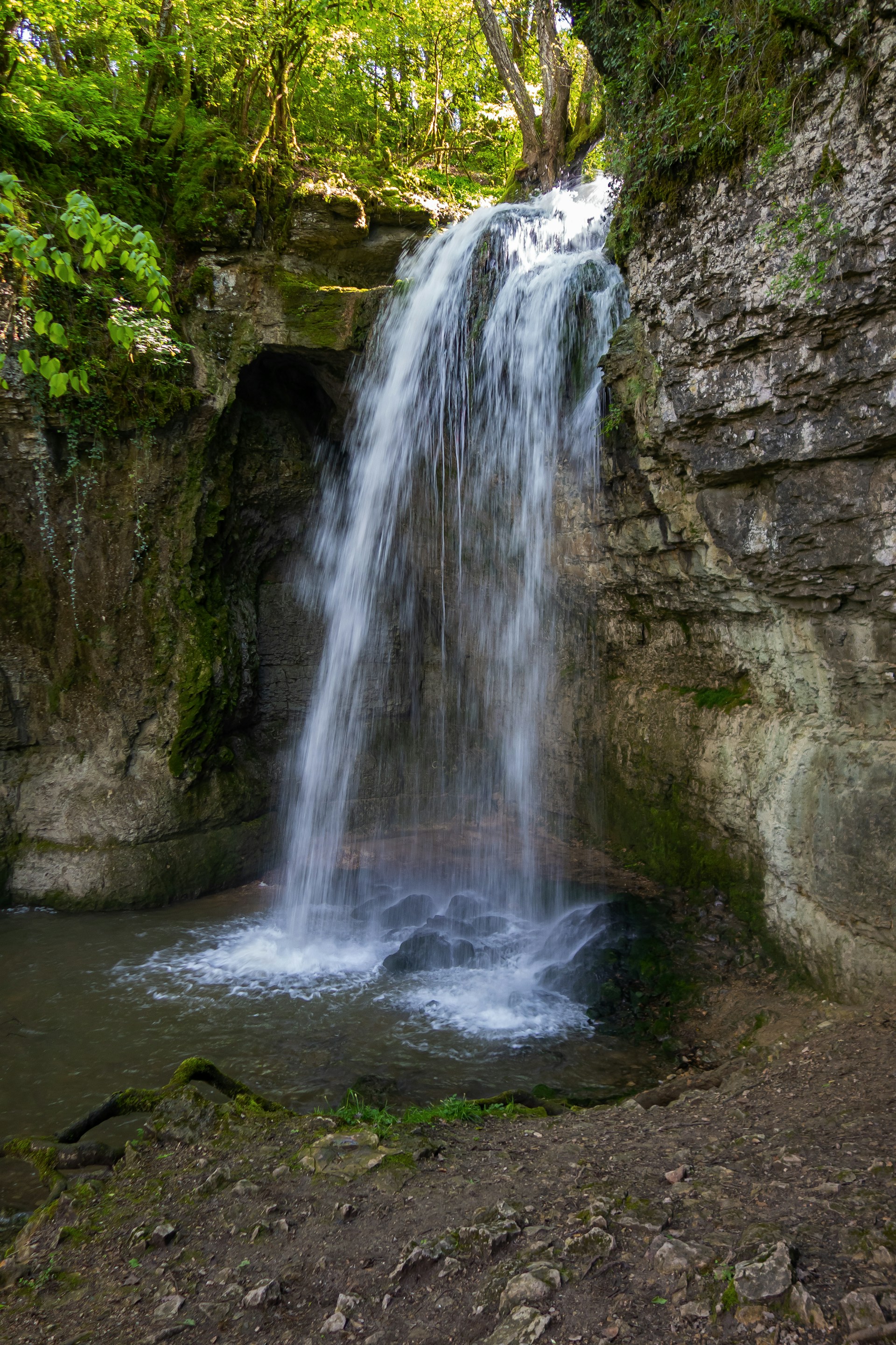 A beautiful waterfall flows into a small pool.