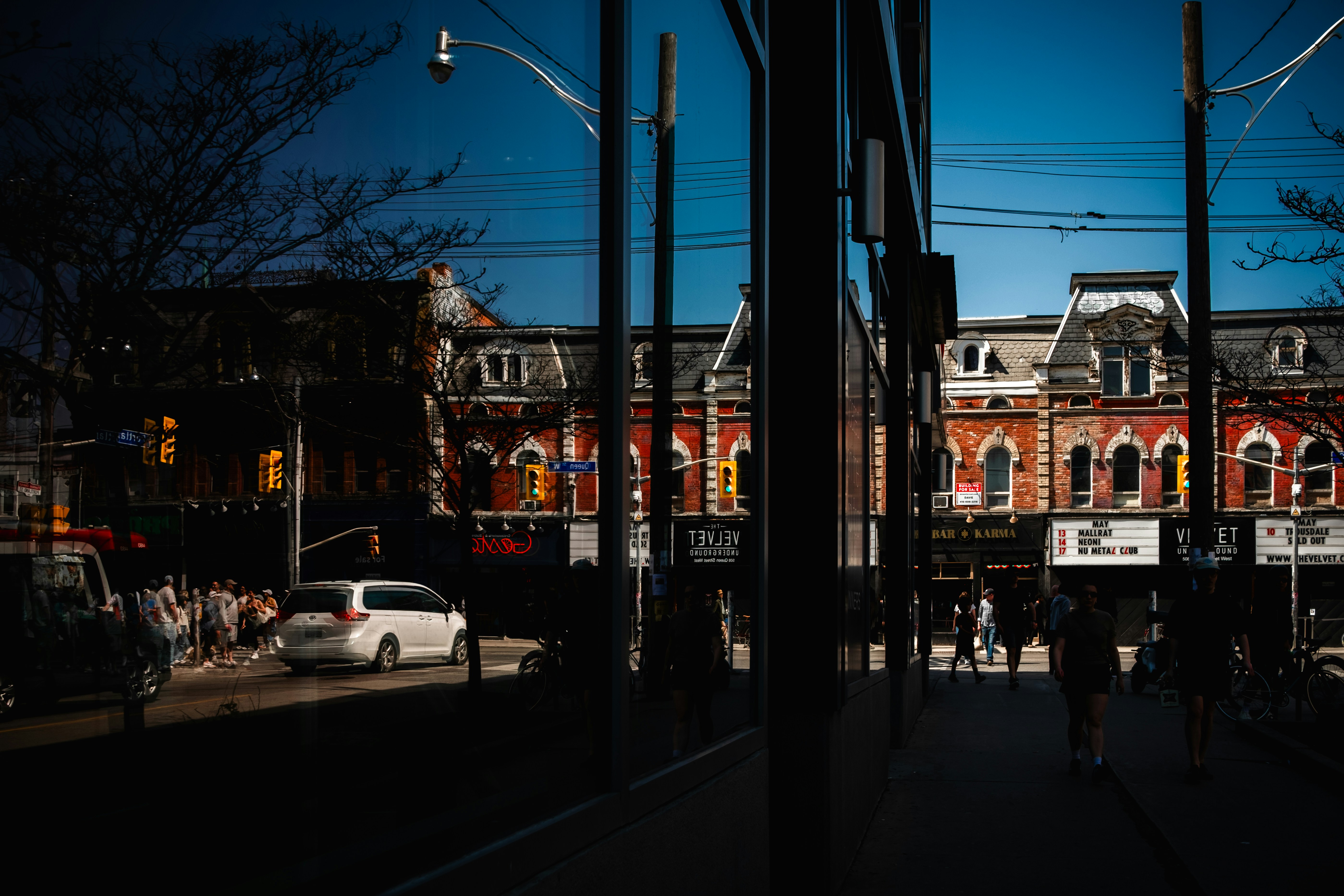 City street scene with buildings and a car.