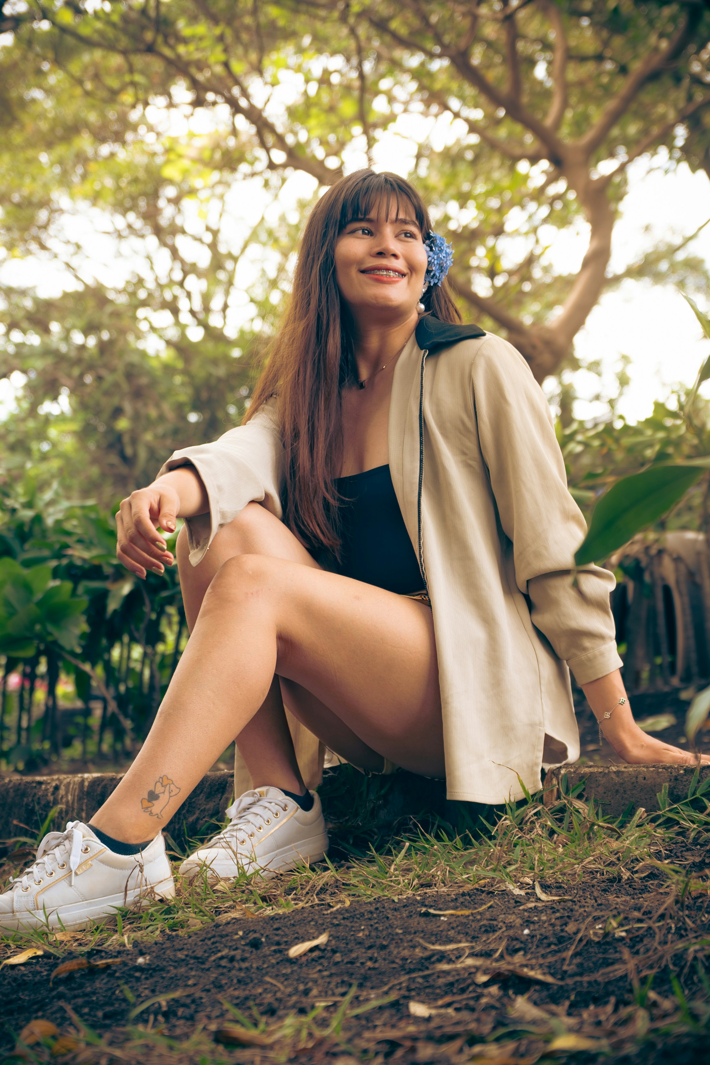 Smiling woman relaxes outside in a park.