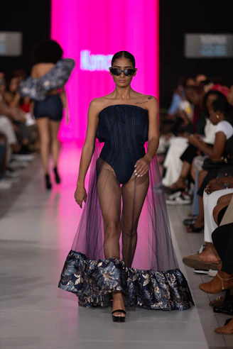 A model walks down the runway in unique attire.