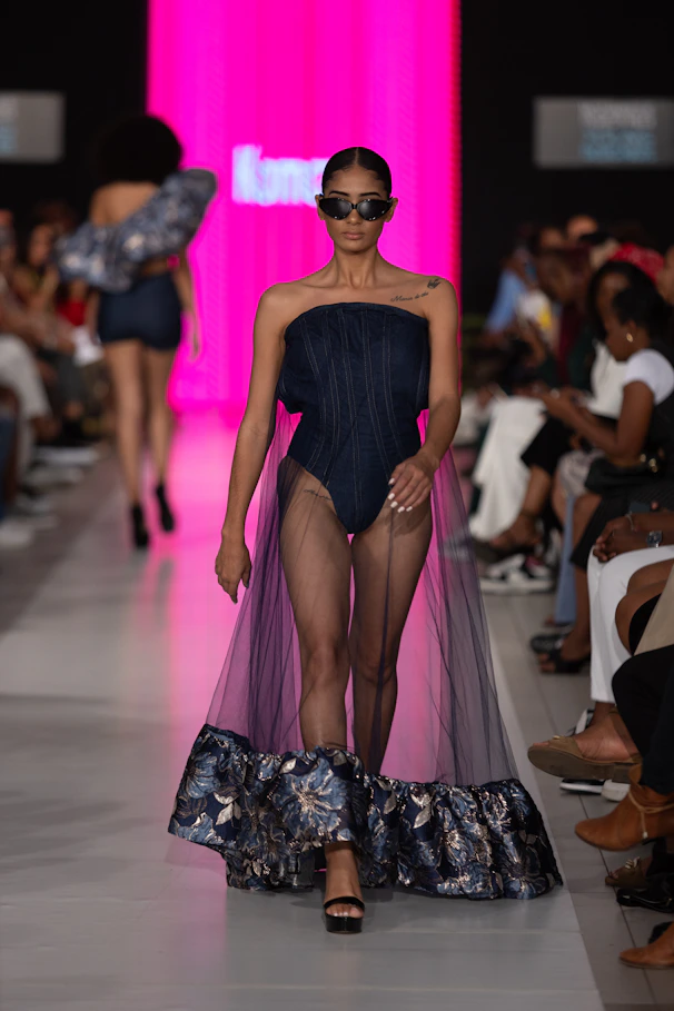 A model walks down the runway in unique attire.
