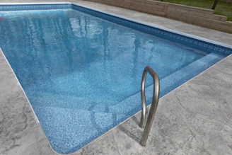 A clean, blue swimming pool awaits.