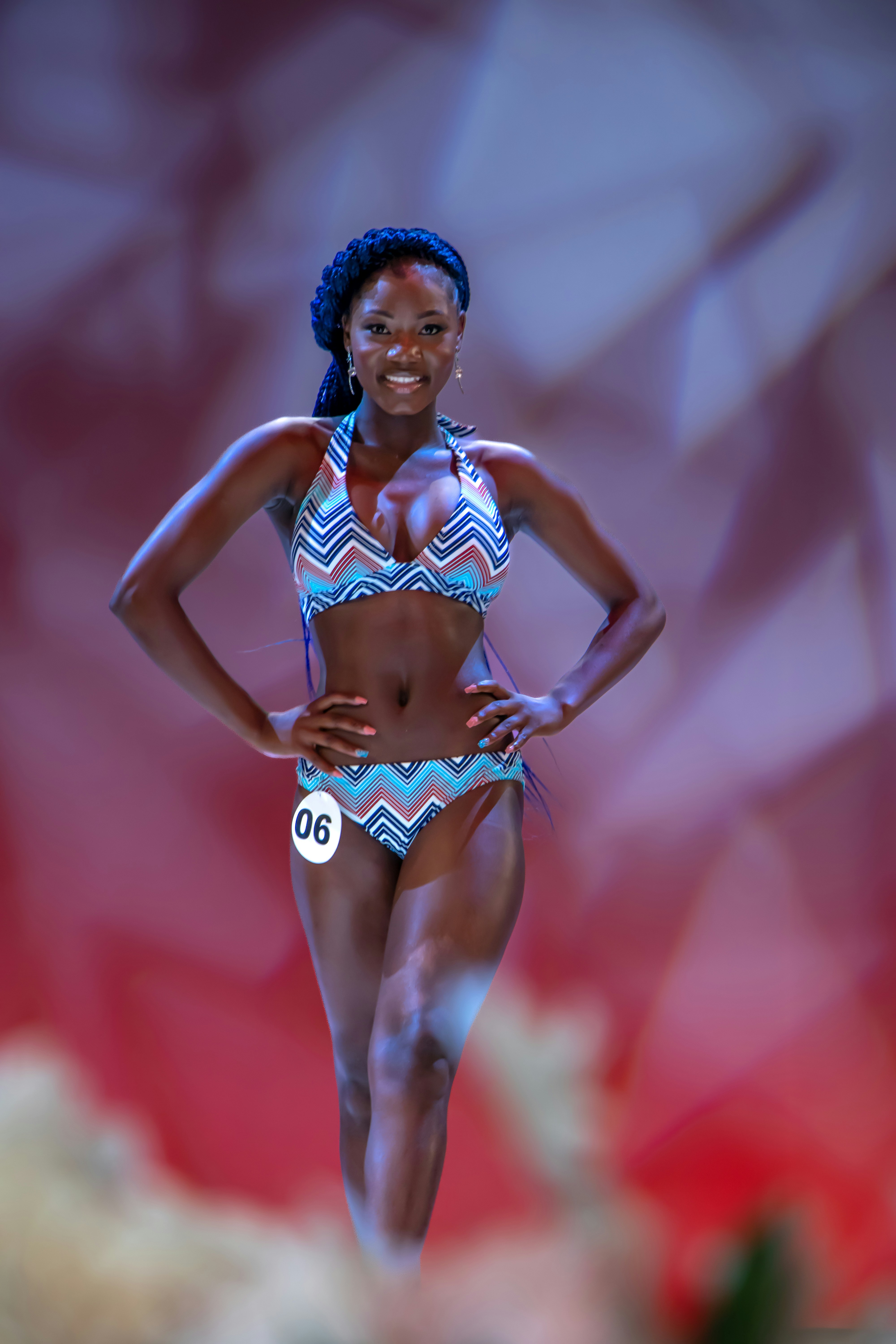 A smiling woman poses in a swimsuit.