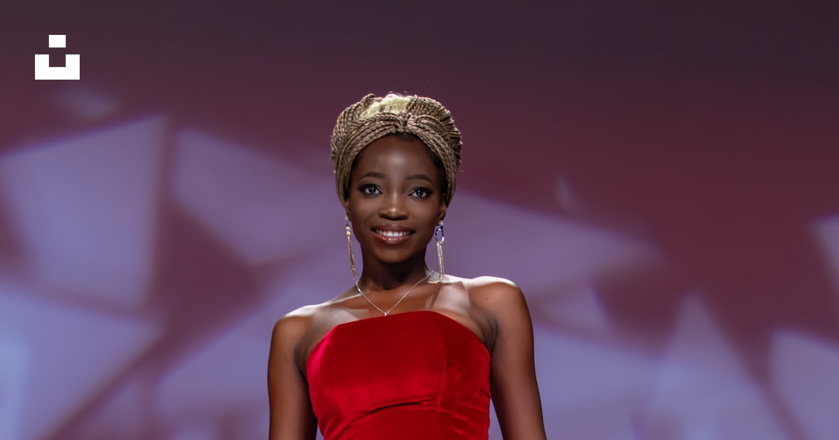 A woman struts down a runway in a red gown. photo – Free Fashion Image ...
