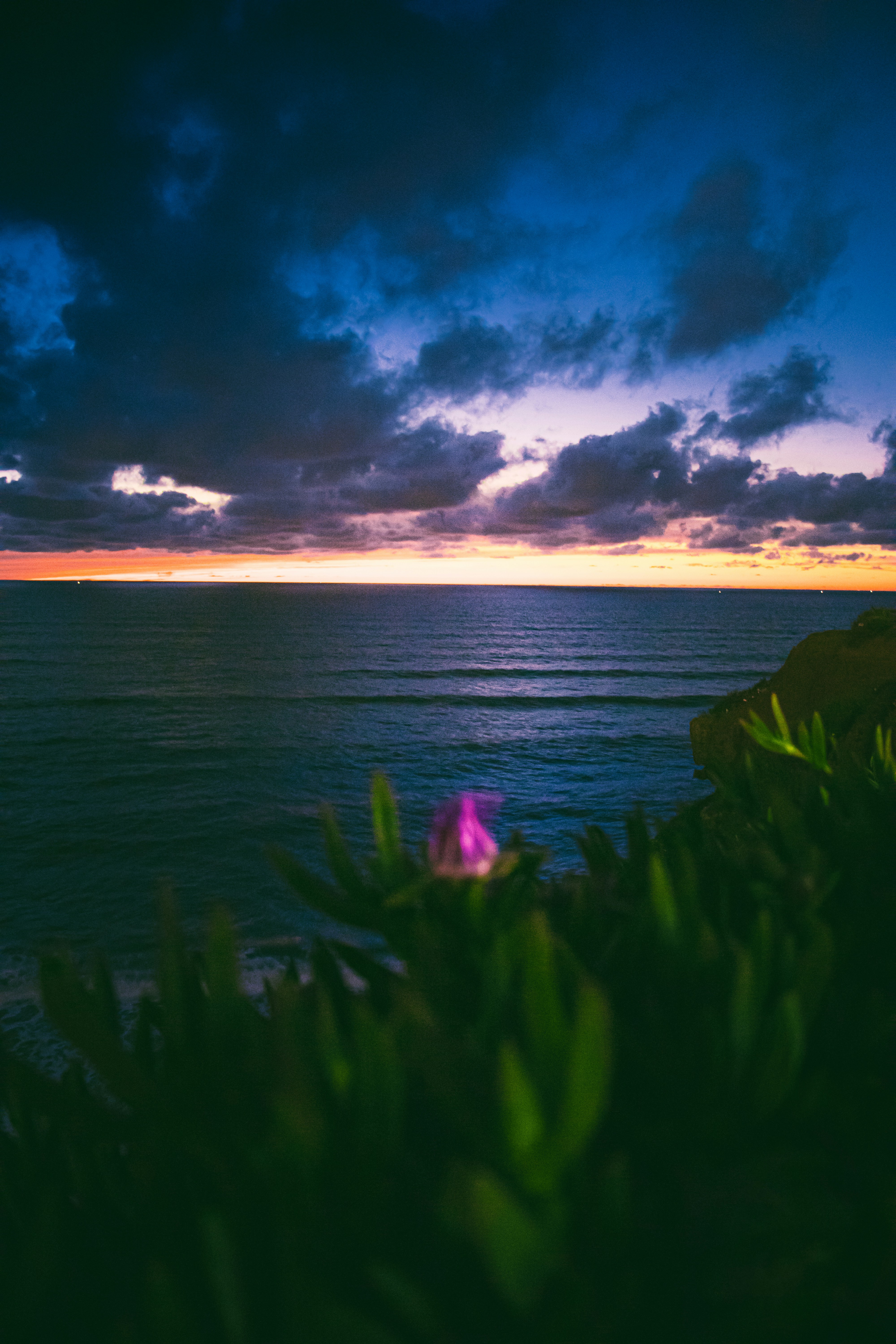 Sunset colors the sky over the ocean.