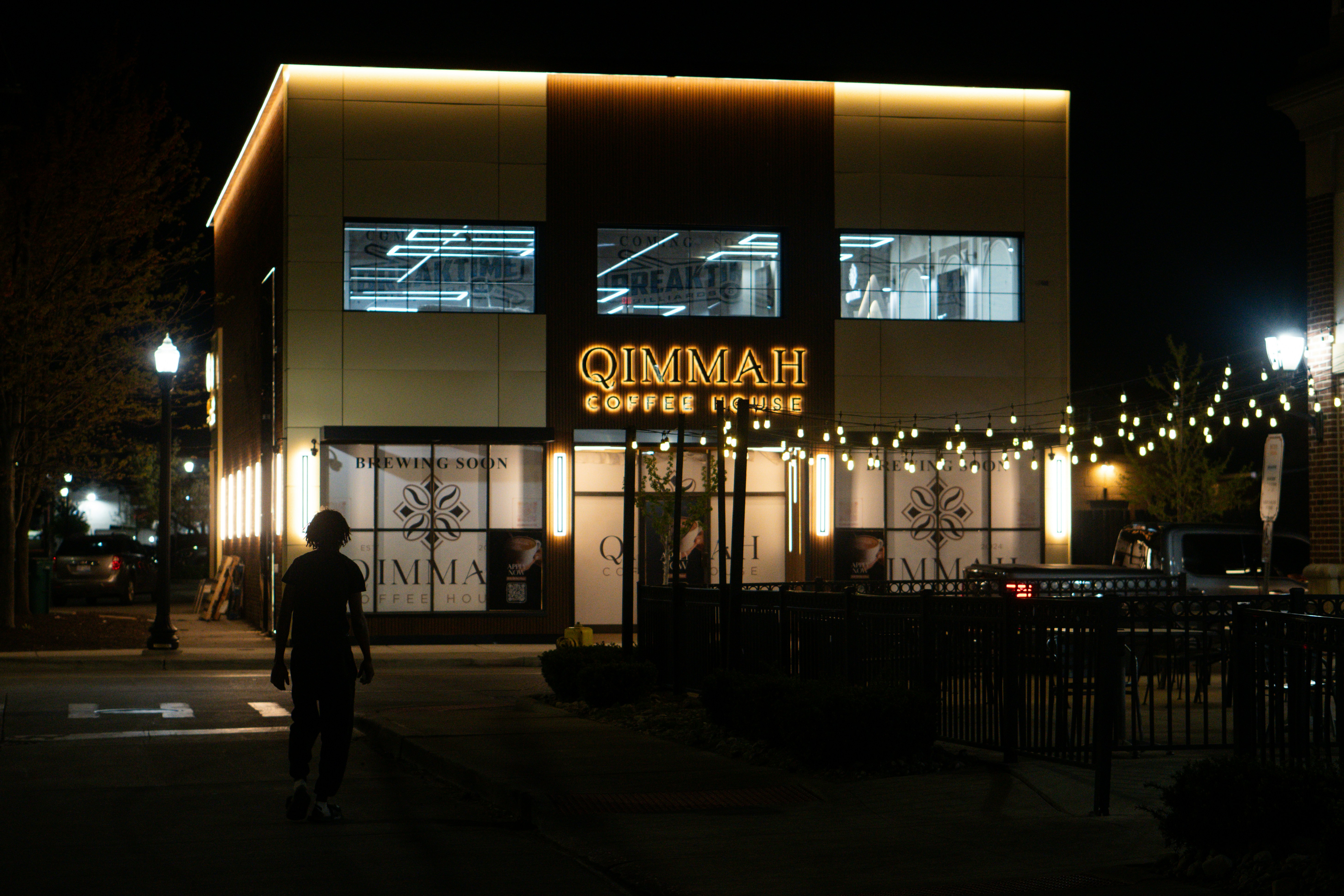A lit-up coffee shop at night.