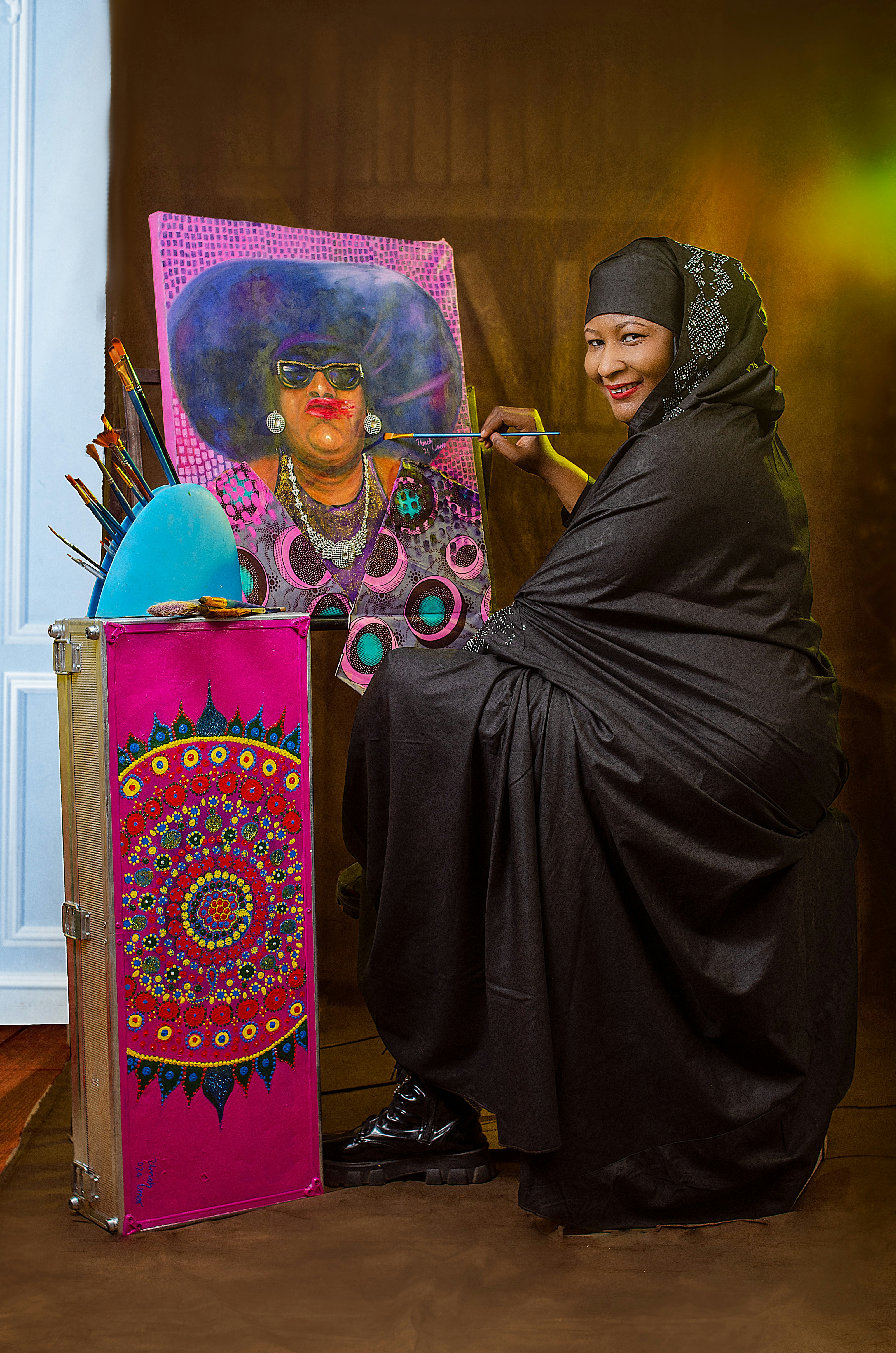 Artist paints a colorful portrait on canvas.