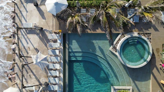 Aerial view of a beach resort's pool and jacuzzi.