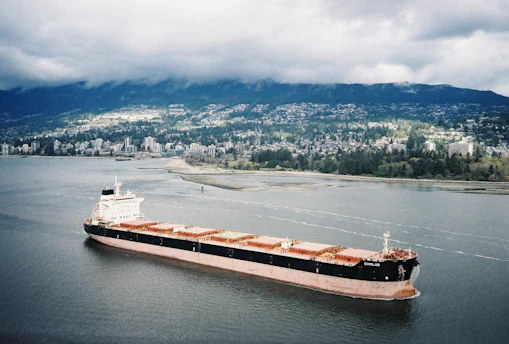 A large cargo ship sails through water